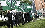 Illustrative: Supporters of the neo-Nazi Nordic Resistance Movement hold flags during a demonstration at the Kungsholmstorg square in Stockholm, Sweden on August 25, 2018. (Fredrik Persson/Getty Images/AFP)