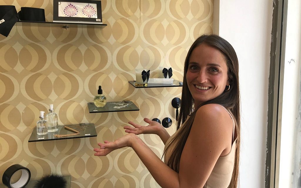 Chana Boteach posing in front of some accessories at her Kosher Sex store in Tel Aviv, July 10, 2019. (Shoshanna Solomon/Times of Israel)