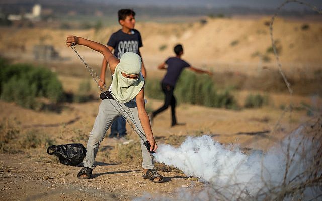 Palestinians rioters clash with Israeli forces on the border near Gaza City, July 26, 2019. (Hassan Jedi/Flash90)
