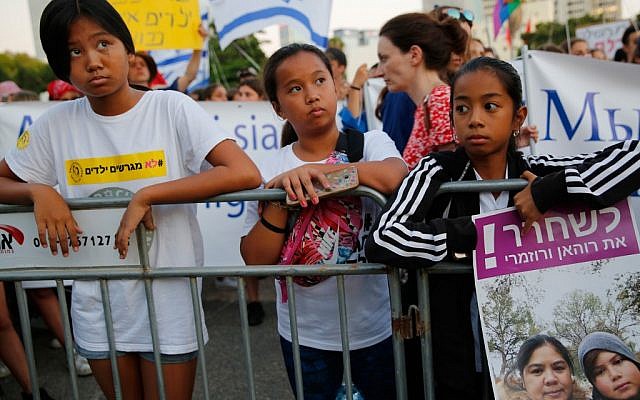 Filipino children carry banners during a protest against deportation in Tel Aviv on August 6, 2019. (Gil COHEN-MAGEN / AFP)