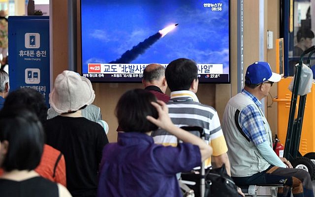 People watch a television news screen showing file footage of North Korea's missile launch, at a railway station in Seoul on August 10, 2019. (Jung Yeon-je / AFP)
