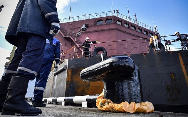 In this file photo taken on May 19, 2018, workers fix mooring line of the floating power unit (FPU) Akademik Lomonosov as it is towed to Atomflot moorage of the Russian northern port city of Murmansk.(Alexander NEMENOV/AFP)