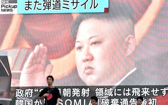 Footage of North Korea's leader Kim Jong Un is seen on a giant television screen in Tokyo on August 24, 2019, reporting on North Korea's missile launch earlier in the day. (Kazuhiro NOGI / AFP)