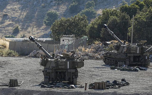 This picture taken on August 25, 2019 from the Israeli side of the Golan Heights shows self-propelled artillery guns positioned along the border with Syria. (Jalaa MAREY / AFP)