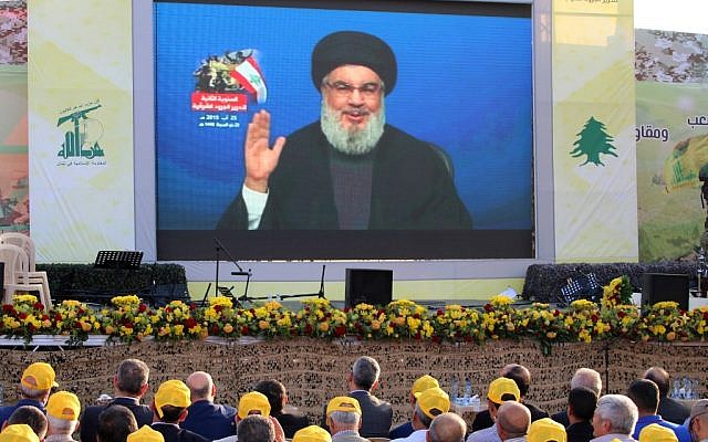 Hezbollah supporters watch a televised speech by the Lebanese terror group’s leader Hassan Nasrallah, in the town of Al-Ain in Lebanon’s Bekaa valley, on August 25, 2019. (AFP)
