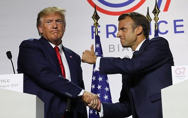 France’s President Emmanuel Macron (R) and US President Donald Trump shake hands during a joint press conference in Biarritz, south-west France on August 26, 2019, on the third day of the annual G7 Summit. (Ludovic MARIN / AFP)