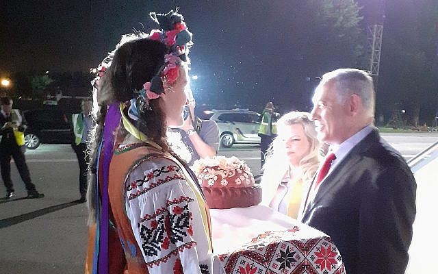 Prime Minister Benjamin Netanyahu and his wife Sara are greeted at the airport in Kiev by Ukrainians dressed in traditional outfits on August 18, 2019. (Raphael Ahren/Times of Israel)