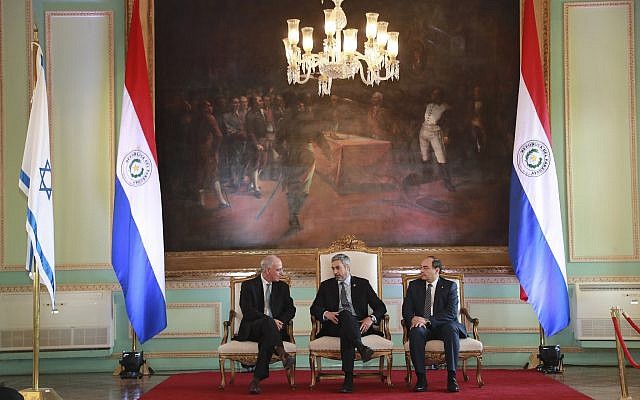 President Mario Abdo Benitez, center, talks to Israel's new ambassador to Paraguay, Yoed Magen, left, as Foreign Minister Antonio Rivas Palacios, right, listens, during official ceremony, at Lopez Palace, Asuncion, Paraguay, August 21, 2019. (Anibal Ovelar/Paraguay's Government Press Office via AP)