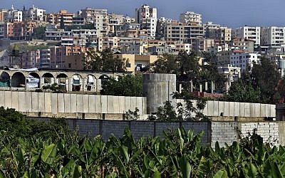 In this May 5, 2017, photo, a general view of the concrete wall surrounding the Ein el-Hilweh Palestinian refugee camp near the southern port city of Sidon, Lebanon (AP Photo/Bilal Hussein)