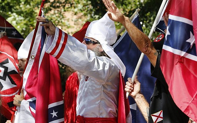 Illustrative: Klan members salute during a KKK rally in Justice Park, July 8, 2017, in Charlottesville, Virginia. (AP Photo/Steve Helber)