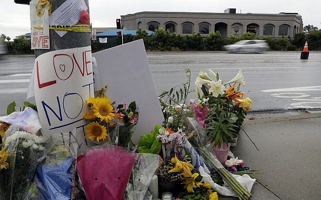 Signs of support and flowers adorn a post in front of the Chabad of Poway synagogue, April 29, 2019, in Poway, California. (AP/Gregory Bull)