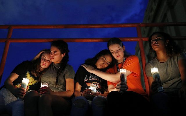 From left, Melody Stout, Hannah Payan, Aaliyah Alba, Sherie Gramlich and Laura Barrios comfort each other during a vigil for victims of the shooting August  3, 2019, in El Paso, Texas. (AP Photo/John Locher)