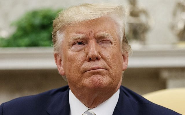 US President Donald Trump winks at a journalist while speaking during a meeting in the Oval Office of the White House,  in Washington, August 20, 2019. (Alex Brandon/AP)