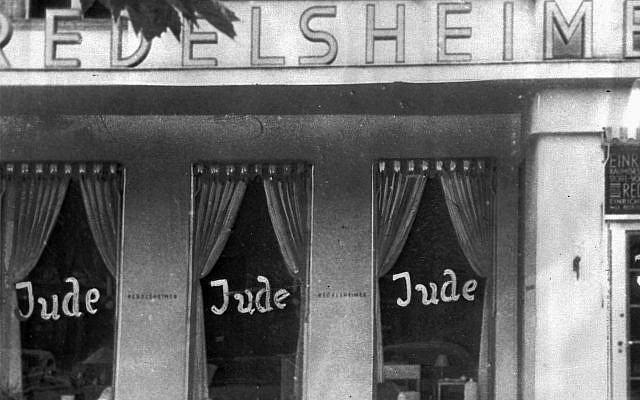 In this June 19, 1938, picture, the word Jude (jew) is smeared on the windows of a shop in Berlin run by Jews. (AP Photo, FILE)