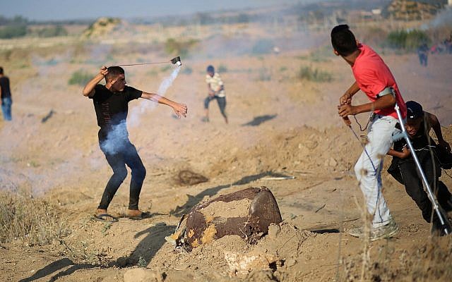 Palestinians protesters clash with Israeli forces during demonstrations at the Israel-Gaza border, near Shuja'iyya neighborhood of Gaza City, August 2, 2019 (Hassan Jedi/Flash90)