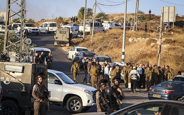 Israeli security forces at the scene where the body of an off-duty, out-of-uniform Israeli soldier was found dead with stab wounds, near the settlement of Migdal Oz in the Etzion region, on August 8, 2019. (Gershon Elinson/Flash90)