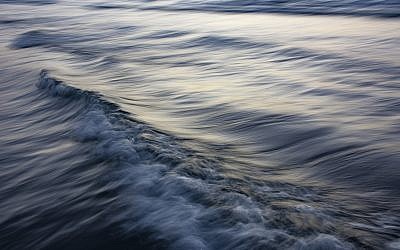 Tal Paz-Fridman's 'The Uniqueness of Waves XXV,' taken at dusk at the Tel Aviv port; for this photographer, the series is a practice of photographic meditation - an attempt to calm the inner waves with awareness of the here and now (Courtesy Tal Paz-Fridman)