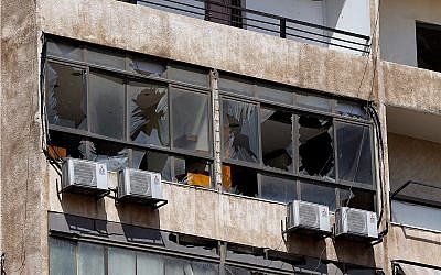 Broken windows are seen on the 11-floor building that houses the media office of Hezbollah in a southern suburb of Beirut, Lebanon, August 25, 2019. (AP Photo/Bilal Hussein)