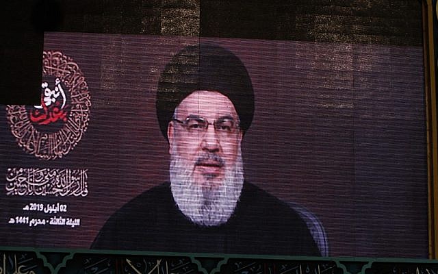 A speech by the Lebanese Shiite Hezbollah terror group's leader Hassan Nasrallah is transmitted on a large screen in the Lebanese capital Beirut's southern suburbs on September 2, 2019. (AFP)