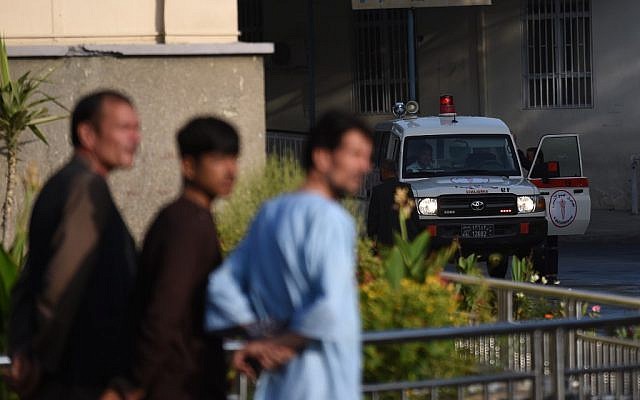 An ambulance is pictured outside Wazir Akbar Khan hospital as people wait after a massive explosion the night before in Kabul on September 3, 2019. (WAKIL KOHSAR / AFP)