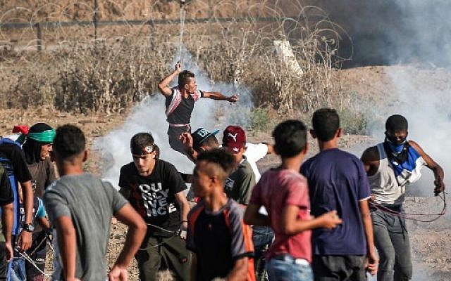 A Palestinian rioter uses a slingshot to hurl a stone at Israeli forces during clashes along the border with Israel east of Bureij in the central Gaza Strip on September 6, 2019. (Mahmud Hams/AFP)