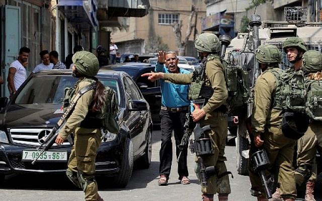 Israeli security forces conduct a search operation following a reported stabbing attack in the West Bank village of Azzun near Qalqilya on September 7, 2019. (Jaafar Ashtiyeh/AFP)