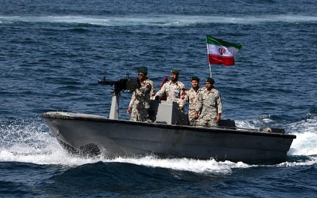 In this file photo taken on April 30, 2019, Iranian military personnel ride in a patrol boat as they take part in the 'National Persian Gulf Day' in the Strait of Hormuz (Photo by ATTA KENARE / AFP)