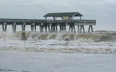 Large waves crashed onto the beach of Tybee Island, Ga., Wednesday, Sept. 4, 2019 as Hurricane Dorian moved closer to the Georgia coast. (Casey Jones/Savannah Morning News via AP)