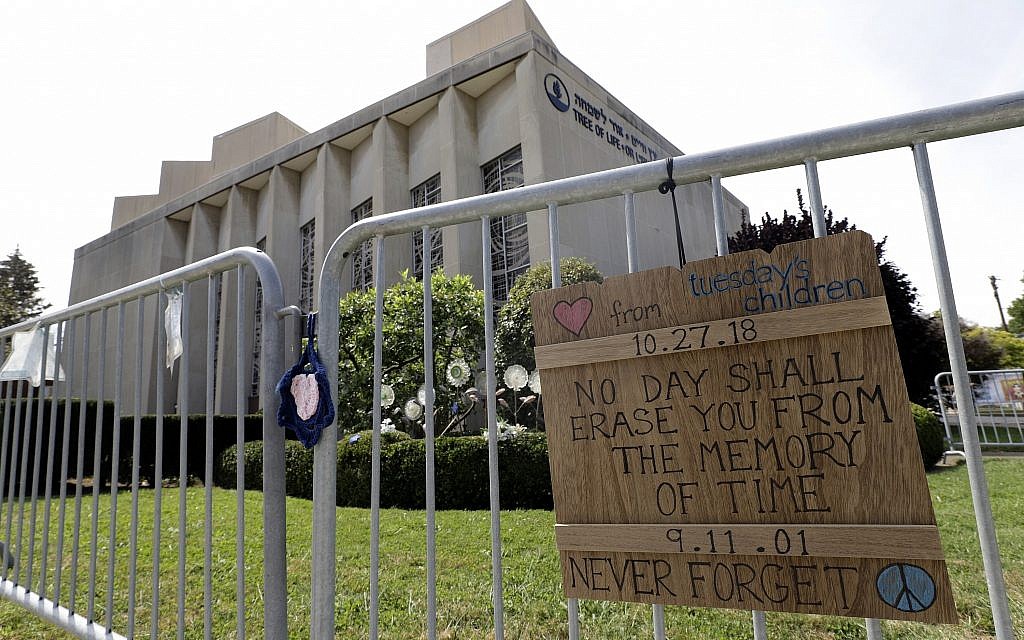 A sign hangs on a fence surrounding the Tree of Life synagogue in Pittsburgh on September 17, 2019. (AP Photo/Gene J. Puskar)