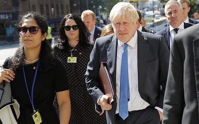 Britain's Prime Minister Boris Johnson walks down the street near United Nations headquarters in New York, September 23, 2019. (AP Photo/Seth Wenig)