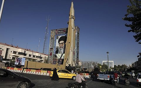 A Shahab-3 surface-to-surface missile is on display next to a portrait of Iranian Supreme Leader Ayatollah Ali Khamenei at an exhibition by Iran's army and paramilitary Revolutionary Guard celebrating 'Sacred Defense Week' marking the 39th anniversary of the start of 1980-88 Iran-Iraq war, at Baharestan Square in downtown Tehran, Iran, September 25, 2019. (AP Photo/Vahid Salemi)