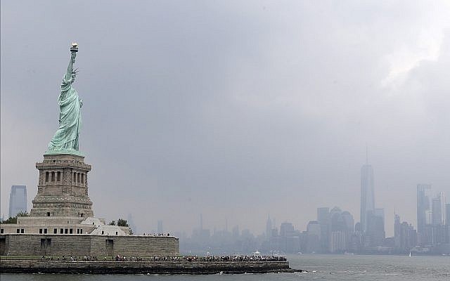 This photo shows the Statue of Liberty on a stormy afternoon in New York on Wednesday, Aug. 14, 2019.  (AP Photo/Kathy Willens)