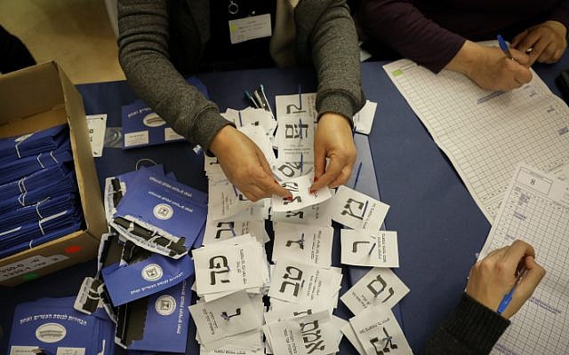 File: Officials count the ballots from soldiers and absentees at the Knesset in Jerusalem, a day after the general election, April 10, 2019 (Noam Revkin Fenton/Flash90)