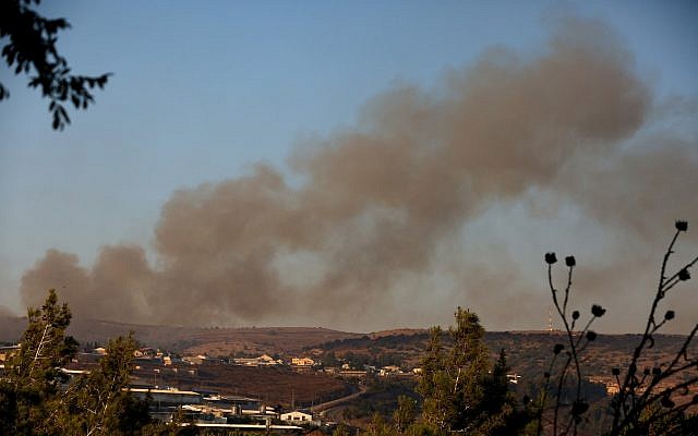 Smoke rises from a fire caused from a rocket fired from Lebanon near Moshav Avivim on the border with Lebanon, in northern Israel, September 1, 2019. (David Cohen/Flash90)