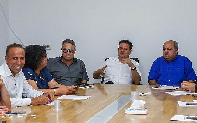Head of the Joint List party Ayman Odeh (second from right) seen with party members during a faction meeting in Kfar Qasim, on September 21, 2019. (Roy Alima/Flash90)