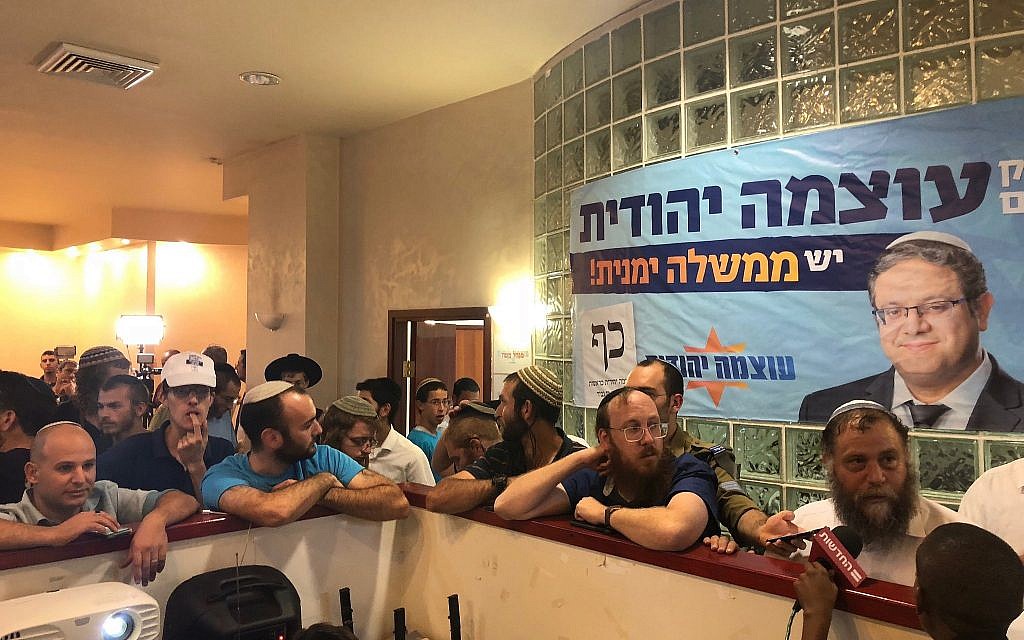Otzma Yehudit supporters watch the exit poll results at the campaign headquarters in Jerusalem on September 17, 2019. (Jacob Magid/Times of Israel)