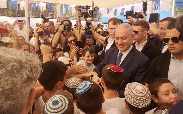 Prime Minister Benjamin Netanyahu meeting schoolkids in the West Bank settlement of Elkana on the first day of school, September 1, 2019. (Courtesy)