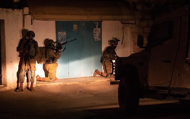 IDF soldiers arrest members of a terror cell behind the August bombing attack that killed Israeli teenager Rina Shnerb, in September 2019. (Israel Defense Forces)