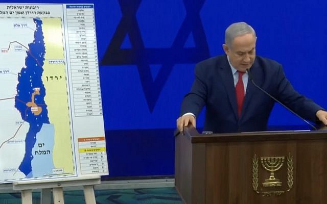 Prime Minister Benjamin Netanyahu delivering a campaign address next to a map of proposed areas of the West Bank for annexation on September 10, 2019. (screen capture: Facebook)