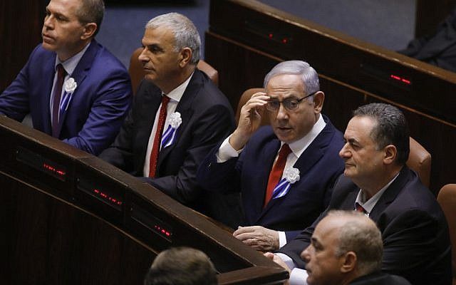 Prime Minister Benjamin Netanyahu (C) fixes his eyeglasses during the swearing-in ceremony at the Knesset in Jerusalem on October 3, 2019 (Menahem KAHANA / AFP)