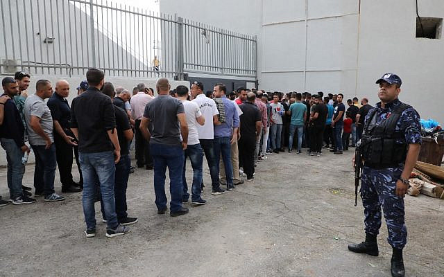 Palestinian football fans line up outside the stadium to watch a World Cup 2022 Asian qualifying match between Palestine and Saudi Arabia in the West Bank town of al-Ram on October 15, 2019. (HAZEM BADER/AFP)