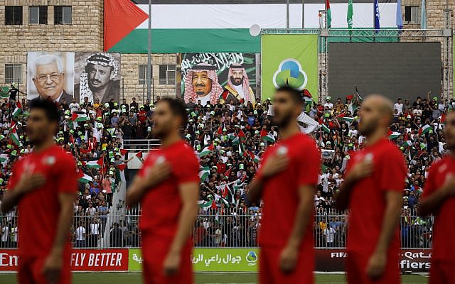 The Palestinian national football team stand for its national anthem during a World Cup 2022 Asian qualifying match between Palestine and Saudi Arabia in the West Bank town of al-Ram on October 15, 2019. (Ahmad GHARABLI / AFP)