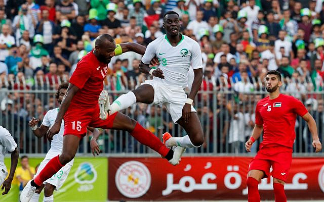 Saudi defender Ziyad Al-Sahafi vies for the ball with Palestine's defender Abdelatif Bahdari during the World Cup 2022 Asian qualifying match between Palestine and Saudi Arabia in the town of al-Ram in the West Bank on October 15, 2019. (Ahmad GHARABLI / AFP)