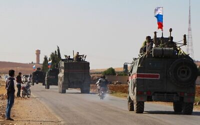A convoy of Russian military vehicles drives toward the northeastern Syrian city of Kobane on October 23, 2019 (AFP)