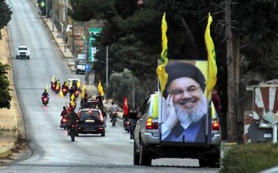 Supporters of the Hezbollah terror group drive in a convoy in support of its leader Hassan Nasrallah's speech, in the area of Fatima's Gate in Kfar Kila on the Lebanese border with Israel, October 25, 2019. (Ali Dia/AFP)