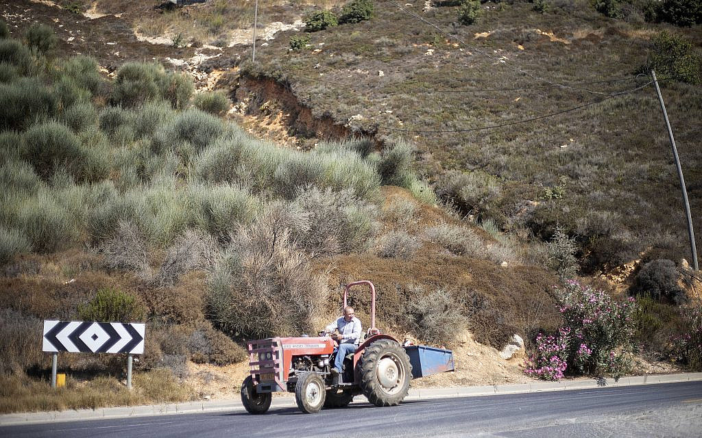 A Druze farmer drives his tractor in the Golan Heights near the border with Syria, Sept. 10 2019. (Ariel Schalit/AP)