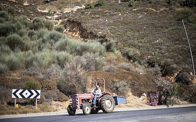 A Druze farmer drives his tractor in the Golan Heights near the border with Syria, Sept. 10 2019. (Ariel Schalit/AP)