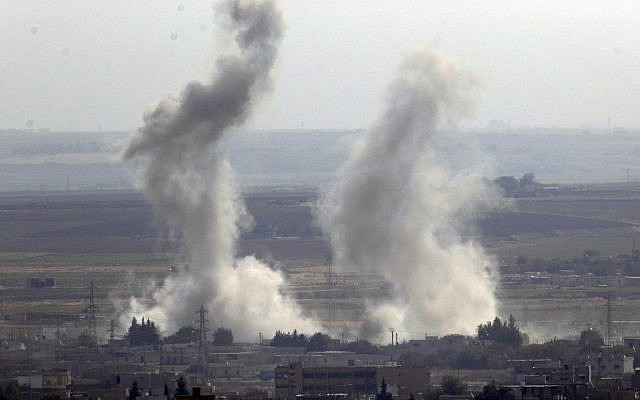 Photo taken from the Turkish side of the border between Turkey and Syria, in Ceylanpinar, Sanliurfa province, southeastern Turkey, showing smoke billowing from targets in Ras al-Ayn, Syria, caused by bombardment by Turkish forces, October 15, 2019. (AP Photo/Cavit Ozgul)