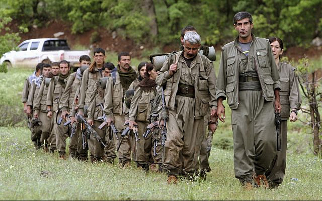 In this photo from May 14, 2013, a group of armed Kurdish fighters from the Kurdistan Workers Party (PKK) enter northern Iraq in the Heror area, northeast of Dahuk. (AP Photo/Ceerwan Aziz, File)