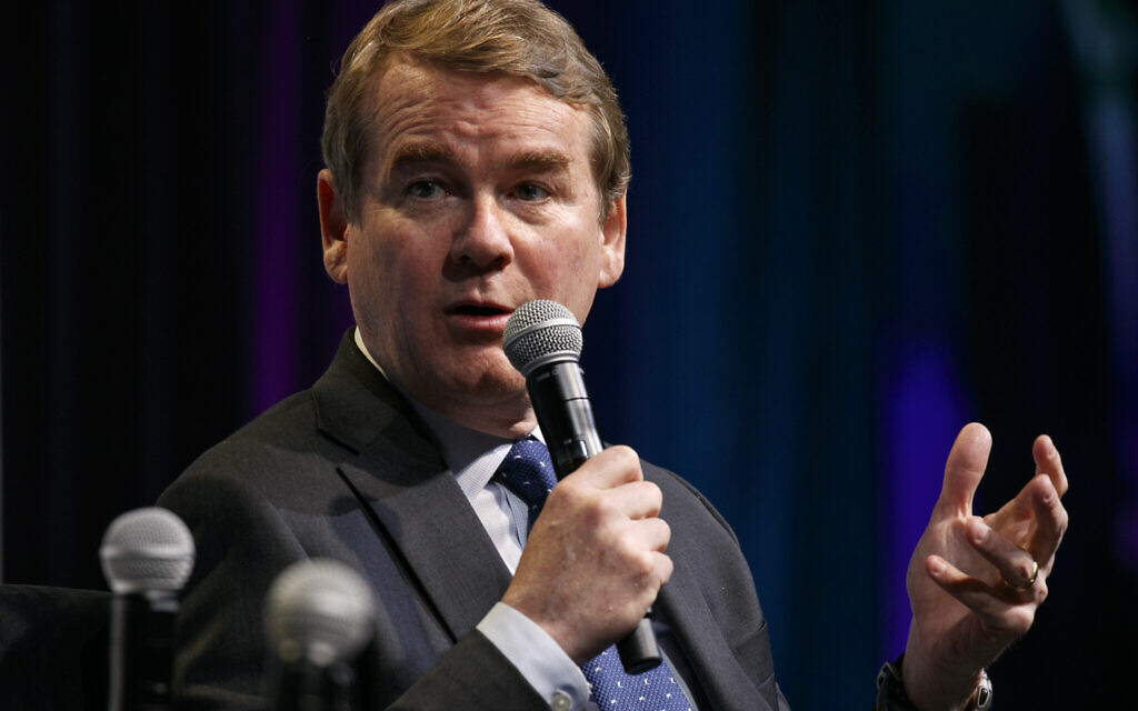 Democratic presidential candidate Sen. Michael Bennet, a Democrat from Colorado, speaks at the J Street National Conference, with the hosts of "Pod Save the World," October 28, 2019, in Washington. (AP Photo/Jacquelyn Martin)